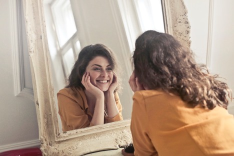 Woman smiling in the mirror